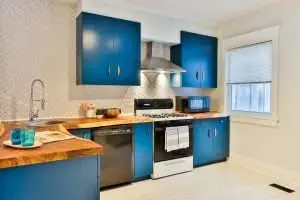 a kitchen space with blue cabinets.